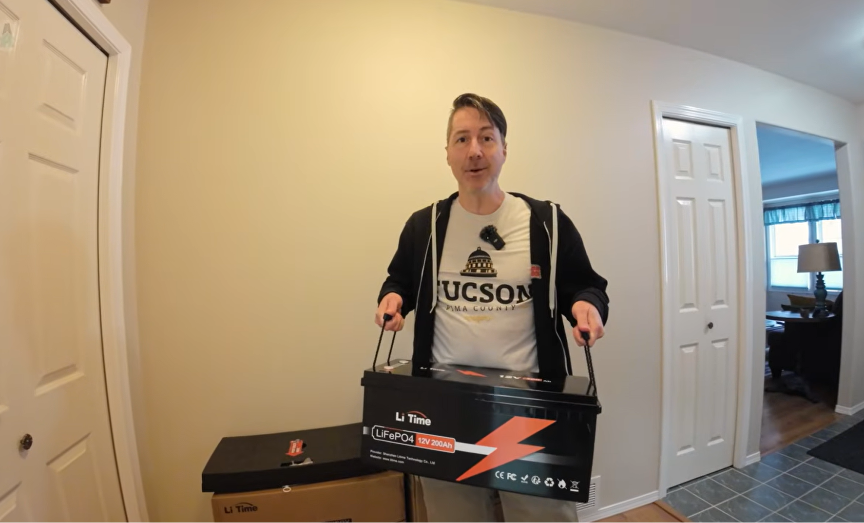a man holding the litime 12v 200ah lifepo4 battery showing its lightweigh features as real customer feedback